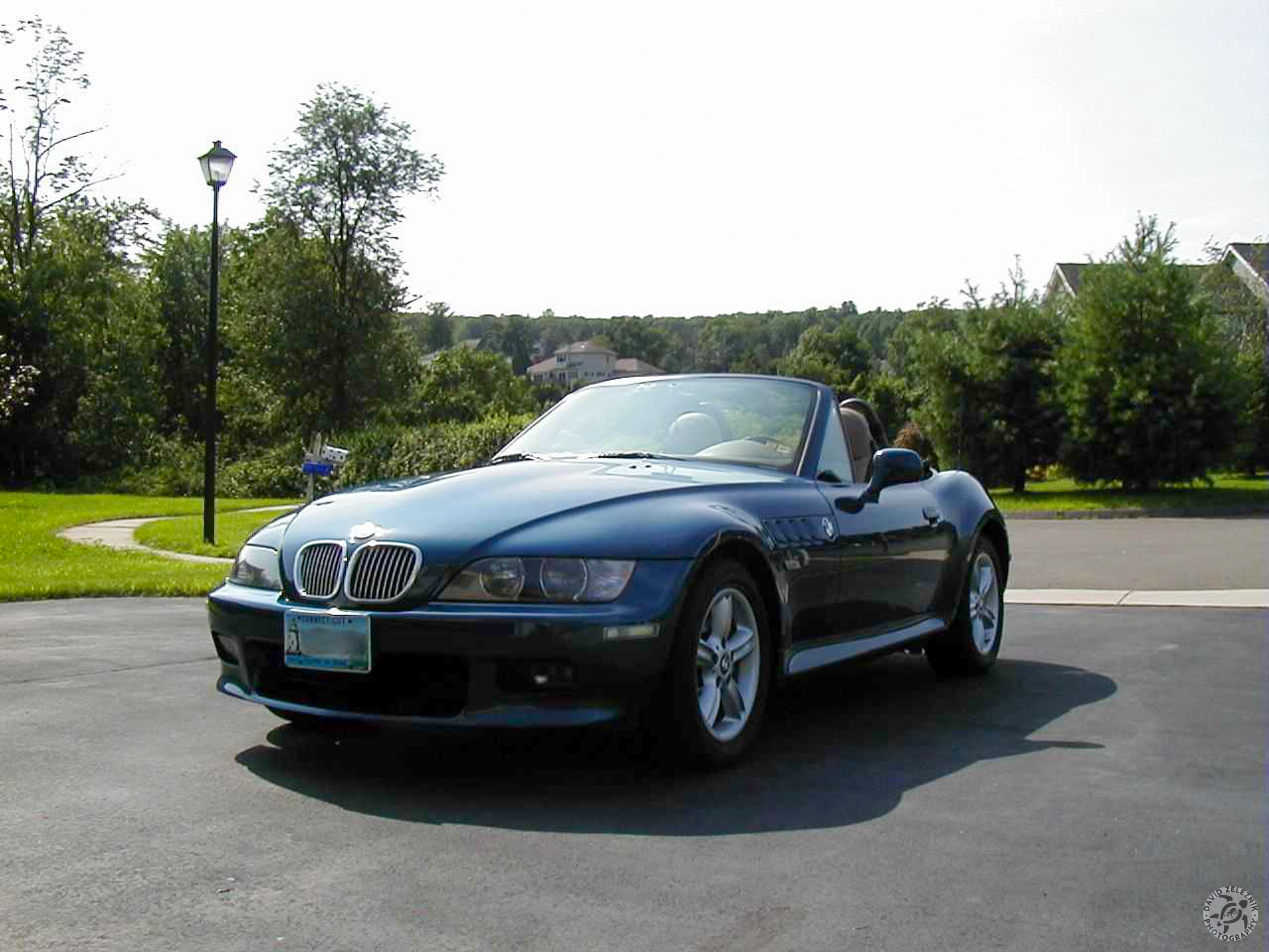 z3_20000804 Fast-forward 8 months and we are in August, 2000. The sun is shining, the hardtop is off, and my wee-little bald spot is getting nice and red from all the top-down driving fun I am having. You can notice that the factory 16" wheels are back on the car. I have also applied a set of Chrom-Design front grill inserts that I purchased from HMS Motorsport .