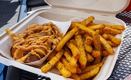 Alaska-029 Max got the Alaskan Buffalo dog with grilled onions and chipotle sauce sans bun, and an order of the garlic cilantro fries that were to die for 🍟