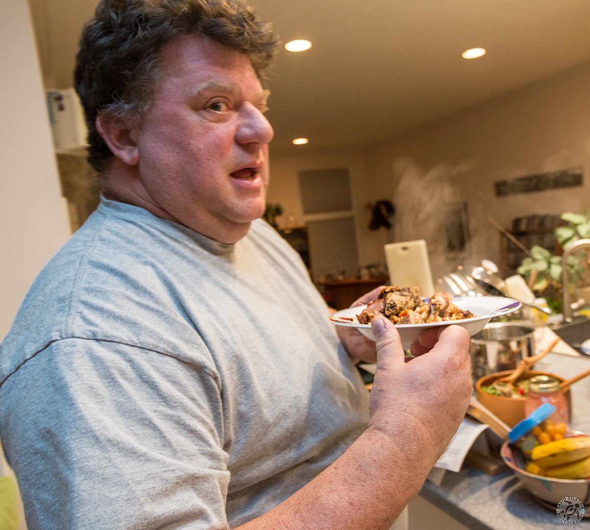 Cassoulet-007 Billy is not sure what to make of the heaping pile of fatty meaty goodness he is holding, but my guess is that the plate will be licked clean very shortly