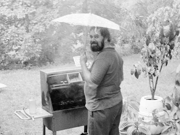 ReivanGrillingInRain-1973-06-003 Rain didn't dampen Reivan's desire to grill while I remained dry taking photos from inside