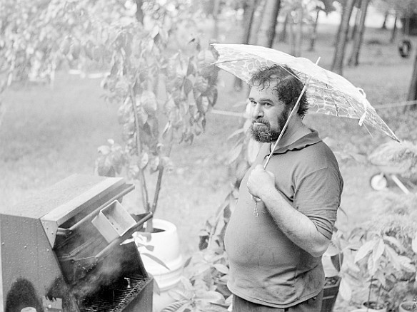 ReivanGrillingInRain-1973-06-007 Reivan was carefree until his umbrella started to break