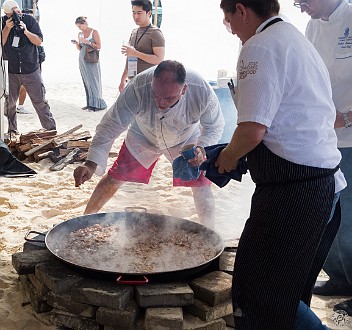 CaymanCookout2013Day1-033 Final stages of the paella. Two giant pans over open fires on the beach