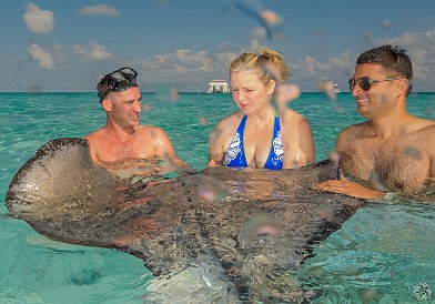 CaymanCookout2015Day2-023 Ilona Thompson and Aseem Chawla, a dentist from Las Vegas, enjoy the group hug