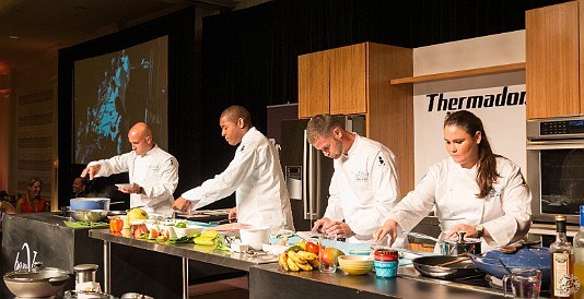 CaymanCookout2015Day3-019 During the champagne brunch, the two finalist teams from the local cooking school compete in a cookoff