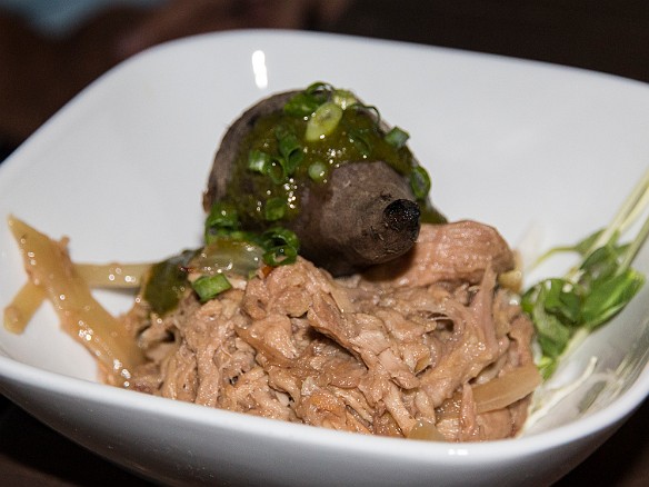 The chef's take on kalua pig, topped with a roasted purple potato, with pea shoots and other garnishes May 22, 2014 7:34 PM