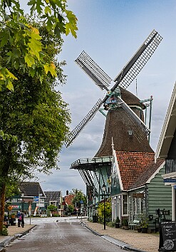 Amsterdam2025-022 Just a block away in the village of Zaandijk Max gets up close and personal with her first windmill. This one is a flour mill, or meelmolen, named De Bleeke...