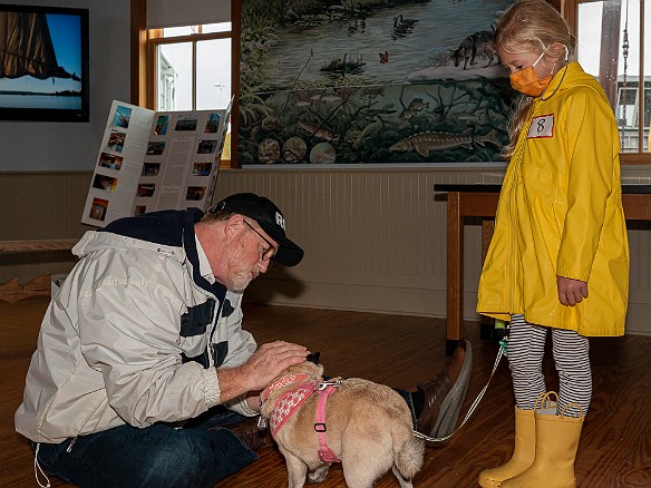 DogsOnTheDock2021-027 Rev. Ken Peterkin of the Essex First Congregational Church gave each dog a blessing in the museum boathouse.