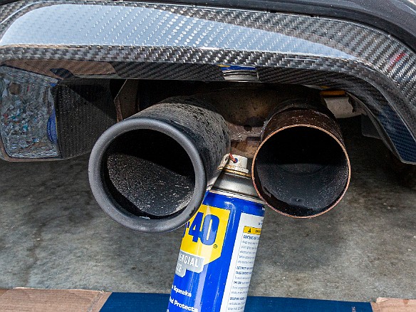 CarbonFiberExhaustTips-005 The stock exhaust tips are held in place by very strong spring retention clips. The first step for removal was to generously spray WD-40 into the back of the...