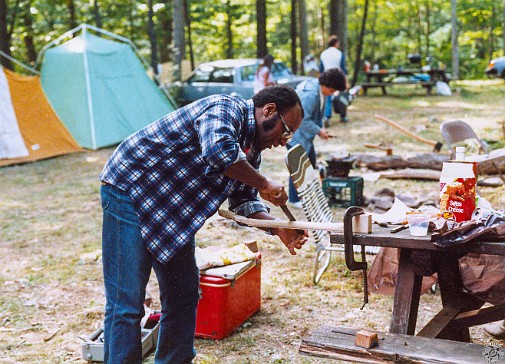 TPB1984-012 Winston set up a makeshift workbench in the campsite to shape a neck he brought from Liberty Banjo